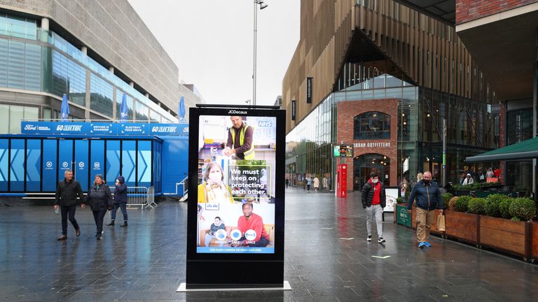 An NHS coronavirus information poster on a digital display in the Liverpool ONE shopping complex in Liverpool city center.