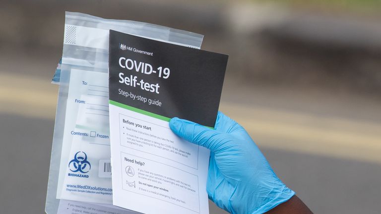 Staff hand out self test kits at a Coronavirus testing centre in Southwark, London.