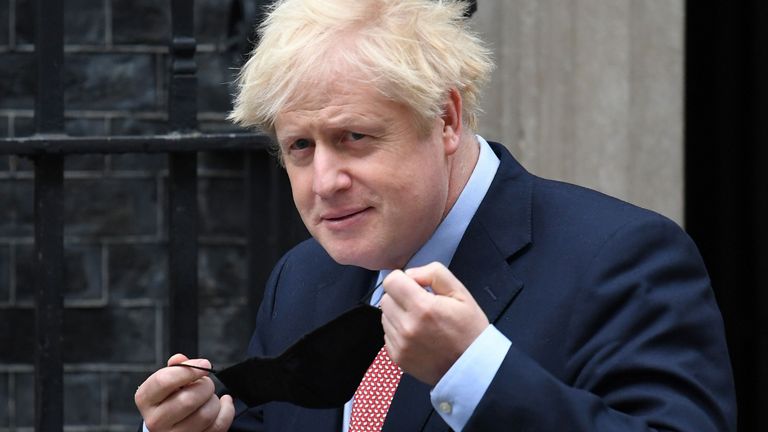 Britain&#39;s Prime Minister Boris Johnson puts on a face covering due to the COVID-19 pandemic, as he leaves 10 Downing Street in central London on October 6, 2020, before giving a speech to the Conservative Party&#39;s annual conference. - British Prime Minister Boris Johnson will seek to banish the coronavirus gloom with a vision of a prosperous future fuelled by floating windmills when he addresses his Conservative party&#39;s annual conference Tuesday. In a speech closing the four-day digital event, he will highlight an election pledge to quadruple the power generated by offshore wind from 10 to 40 gigawatts this decade, saying it would support 60,000 new jobs. (Photo by Daniel LEAL-OLIVAS / AFP) (Photo by DANIEL LEAL-OLIVAS/AFP via Getty Images)