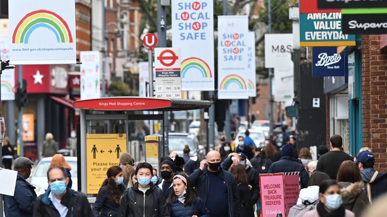 Pedestrians and shoppers, some wearing face masks as a precaution against the transmission of the novel coronavirus, walk in the high street in west London on October 11, 2020. - Prime Minister Boris Johnson is expected to outline the new regime on Monday as rates of Covid 19 infection surge particularly in the north, worsening a national death toll of more than 42,000 which is already the worst in Europe. (Photo by JUSTIN TALLIS / AFP) (Photo by JUSTIN TALLIS/AFP via Getty Images)