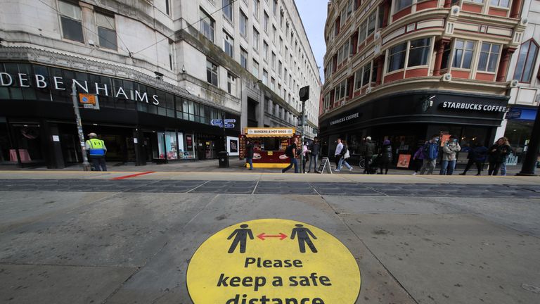 A social distancing guidance sign on the pavement in Manchester city centre. Cities in northern England and other areas suffering a surge in Covid-19 cases may have pubs and restaurants temporarily closed to combat the spread of the virus.
