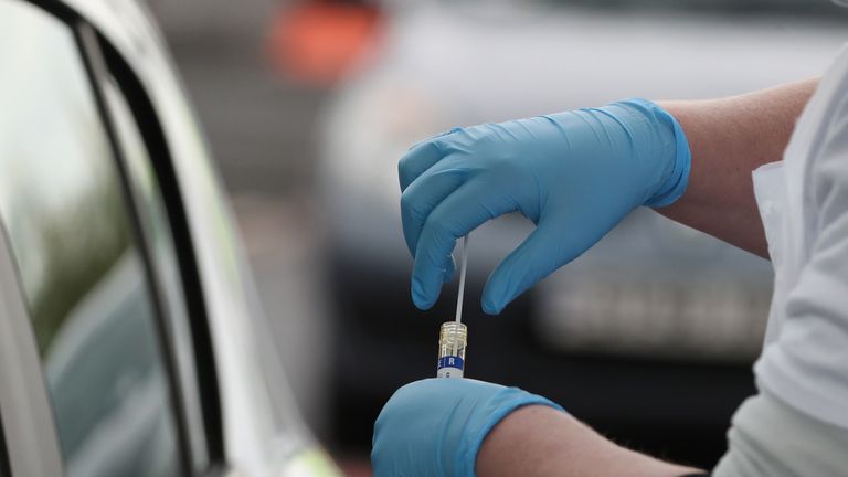 A test sample is held at a Covid-19 testing centre at Glasgow Airport, as the UK continues in lockdown to help curb the spread of the coronavirus.