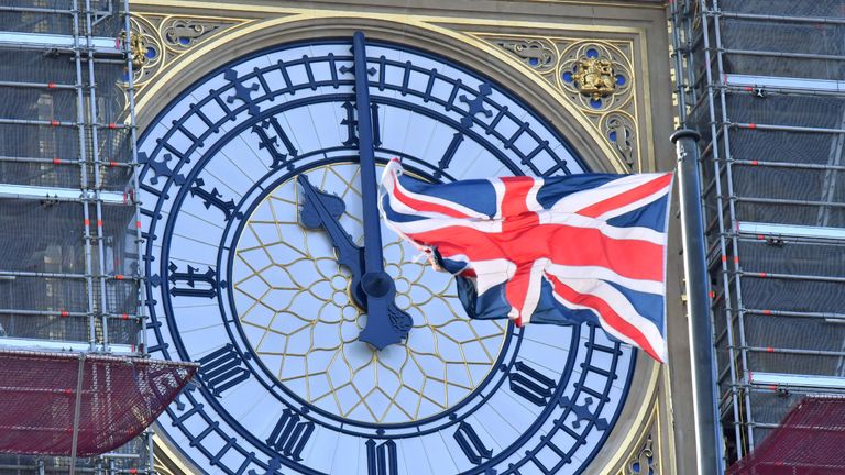 TOPSHOT - The clock face of Elizabeth Tower, known after the bell Big Ben, shows the hands at eleven o'clock as a Union Flag flies in front of it in London on January 28, 2020. - Britain will formally leave the European Union at 11pm GMT on January 31, 2020. (Photo by Justin TALLIS / AFP) (Photo by JUSTIN TALLIS/AFP via Getty Images)