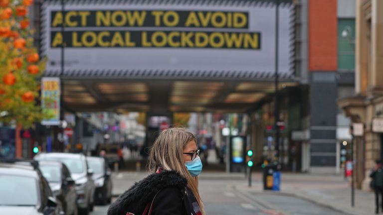 A woman wearing a face mask in Manchester city centre as the row over Greater Manchester's coronavirus status continues.