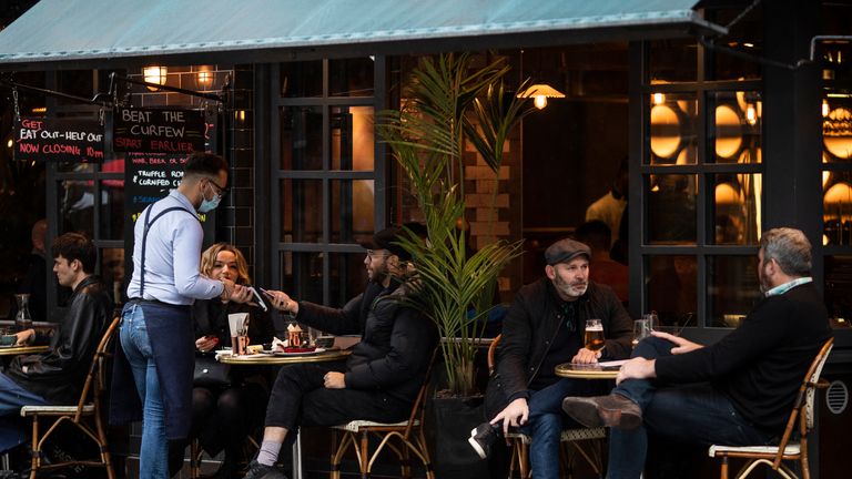 LONDON, ENGLAND - OCTOBER 13: Customers sit outside a restaurant/cafe bar in Soho on October 13, 2020 in London, England. London Mayor Sadiq Khan said today that the city would move into Tier 2 of the government's new Covid-19 risk classification once it hits 100 new daily cases per 100,000 people, which could happen this week. The second or "high" tier of the three-tier system triggers a ban on household mixing, although pubs would remain open. (Photo by Dan Kitwood/Getty Images)