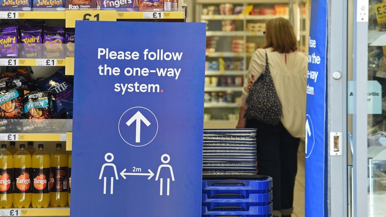 A sign instructing shoppers to maintain social distancing is seen at the entrance to a Tesco supermarket in Lincoln, Eastern England on April 20, 2020, as life in Britain continues during the nationwide lockdown to combat the novel coronavirus pandemic. - The number of people in England who have died in hospital from coronavirus has risen by 429 to 14,929 according to daily health ministry figures on Monday, April 20. (Photo by Oli SCARFF / AFP) (Photo by OLI SCARFF/AFP via Getty Images)