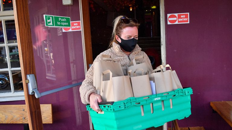 Volunteer Elise Barnard prepares free packed lunch bags for delivery at the Gallimaufry pub in Bristol, who are providing free school meals for children over the half term holidays. Local councils and businesses are continuing to pledge free food for children in need during this week's half term break after the Government defeated a Labour motion to extend free school meals provision in England over the holidays.