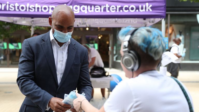 Mayor of Bristol Marvin Rees (left) joins other members of Bristol City Council as they hand out 80,000 face masks in Bristol city centre as face coverings become mandatory in shops and supermarkets in England.