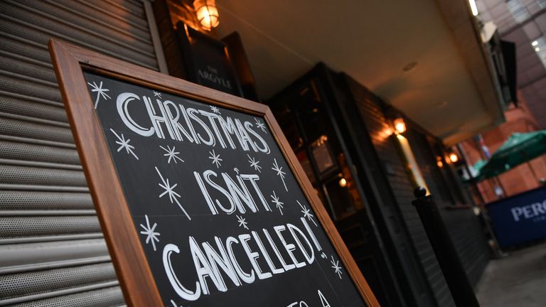 A sign outside a pub advertises a Christmas venue in London on October 21, 2020, as the government considers further lockdown measures to combat the rise in novel coronavirus COVID-19 cases. - Britain has suffered Europe's worst death toll from coronavirus, with nearly 44,000 deaths within 28 days of a positive test result. After a summer lull, cases are rising again as in other parts of the continent -- and so are deaths, with 241 reported on Tuesday alone. (Photo by JUSTIN TALLIS / AFP) (Photo by JUSTIN TALLIS/AFP via Getty Images)