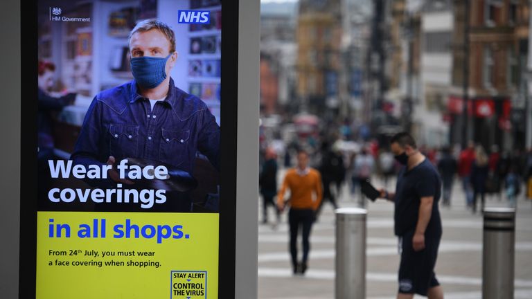 A sign calling for the wearing of face-masks in shops is displayed  in the city centre of Leeds, on July 23, 2020, as lockdown restrictions continue to be eased during the novel coronavirus COVID-19 pandemic. - The wearing of facemasks in shops in England will be compulsory from Friday, but full guidance is yet to be published. (Photo by Oli SCARFF / AFP) (Photo by OLI SCARFF/AFP via Getty Images)