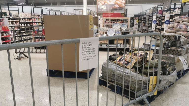 Products including cups and plates are seen behind a barrier at  Tesco in Pengam Green