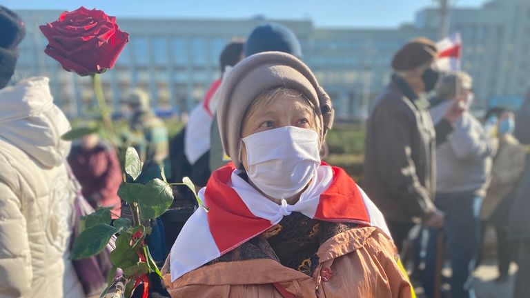 81-year old-Nina, clutching a rose, said she goes to every rally and isn&#39;t scared of the authorities. Pic: Anastasia Leonova 