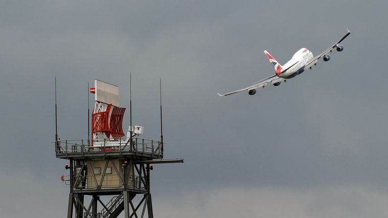 A British Airways Boeing 747 "Jumbo Jet" takes off past a radar at London Heathrow Airport, on March 25, 2010