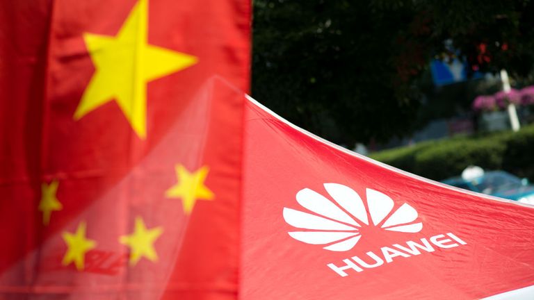 A logo of Huawei Technologies Co Ltd is seen next to a Chinese flag in Shanghai on October 1, 2014. The founder of Chinese telecommunications giant Huawei announced plans to invest 1.5 billion euros ($1.9 billion) in France to develop smartphones, the online edition of Les Echos business daily reported Monday. AFP PHOTO / JOHANNES EISELE (Photo by Johannes EISELE / AFP) (Photo credit should read JOHANNES EISELE/AFP via Getty Images)
