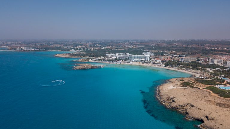 AYIA NAPA, CYPRUS - JULY 12 : Aerial view of Nissi beach on July 12, 2020 in Ayia Napa, Cyprus. Nissi beach is a sandy beach with clean turquoise waters and the beach awarded with a blue flag designation. The beach which runs the length of its own cove, takes its name from the small islet located close to the coast. The uninhabited is let can be easily reached on foot through the shallow waters and its location provides a good shelter for the rest of the beach. (Photo by Athanasios Gioumpasis/Ge