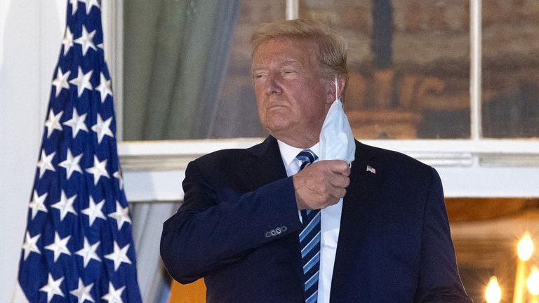 Donald Trump removes his mask upon return to the White House on Monday night