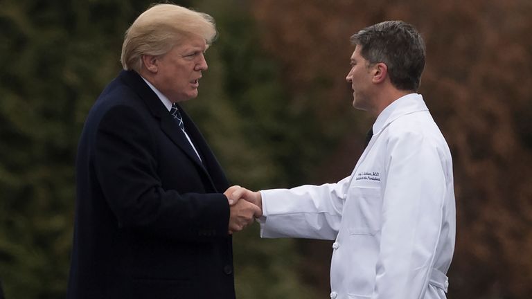 US President Donald Trump shakes hands with White House Physician Rear Admiral Dr. Ronny Jackson, following his annual physical at Walter Reed National Military Medical Center in Bethesda, Maryland, January 12, 2018. / AFP PHOTO / SAUL LOEB (Photo credit should read SAUL LOEB/AFP via Getty Images)
