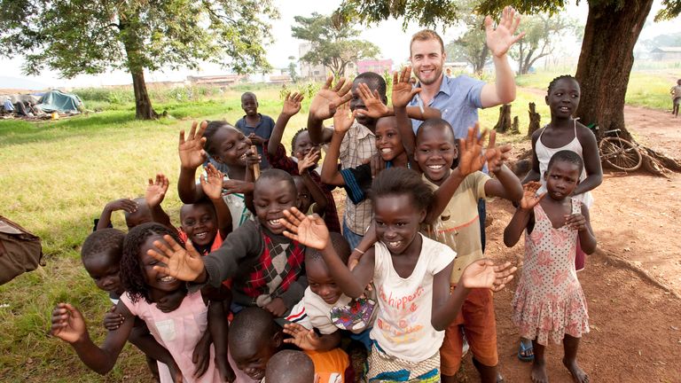 Gary Barlow poses with local children in Uganda