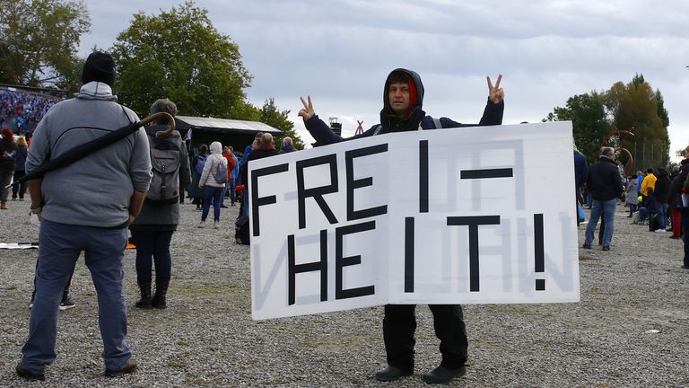 A man protesting against the restrictions held a sign saying &#39;freedom&#39;