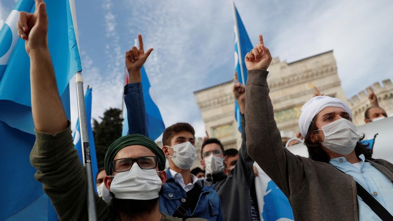 Mask-wearing protesters are seen at a demonstration in Istanbul on Sunday