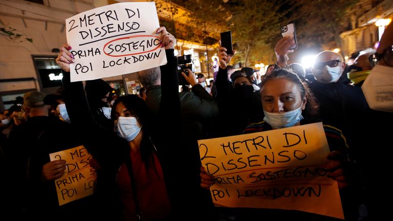 The spread of coronavirus disease (COVID-19) in Naples
Shop owners hold signs during a protest against restrictive measures in Naples as new coronavirus disease (COVID-19) cases soar to new records in Naples, Italy, October 25, 2020. The sign reads: "2 meter of protest, first welfare then lockdown" REUTERS/Ciro De Luca