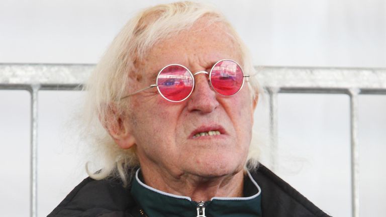 Jimmy Savile watches Britain's Queen Elizabeth II name Cunard's newest cruise ship, the Queen Elizabeth in Southampton.  Read less Photos by: Chris Ison / PA Archive / PA Images Date taken: 11-10-2010