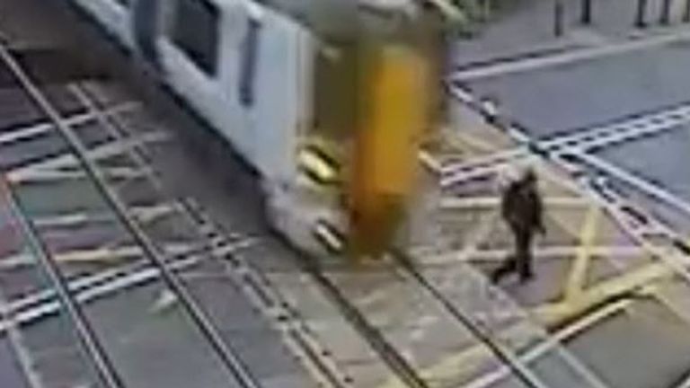 Man has lucky escape after walking across level crossing with the barriers down