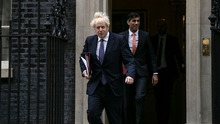 Rishi Sunak (R) accompanies Boris Johnson as he leaves Downing Street 