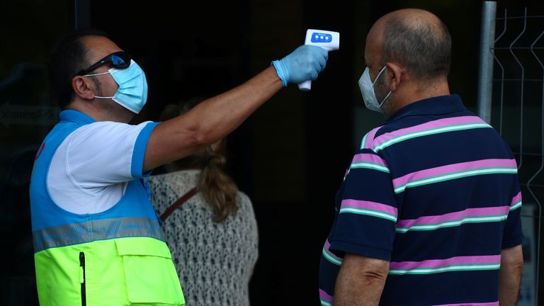 A man gets his temperature checked in Vallecas, Madrid, which has been under partial lockdown