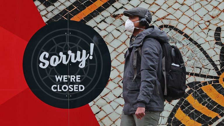 A man wearing a face mask in Manchester city centre as the row over Greater Manchester&#39;s coronavirus status continues.
