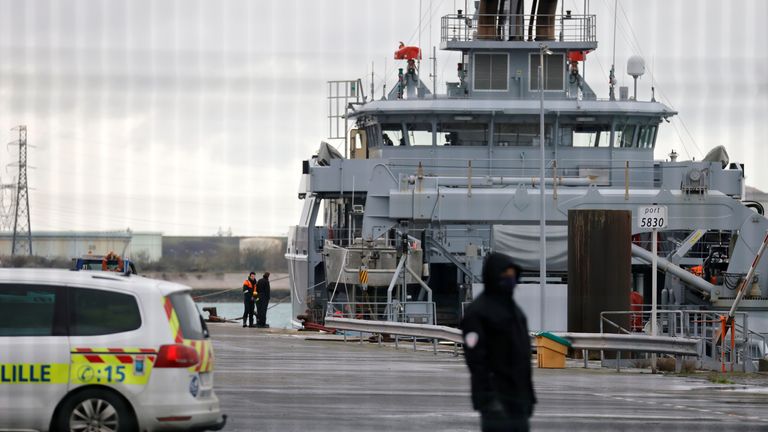 A policeman stands next to a rescue vessel during a search operation after a boat carrying about 20 migrants capsized off the coast of Loon-Plage near Dunkirk, northern France, October 27, 2020. REUTERS/Pascal Rossignol
