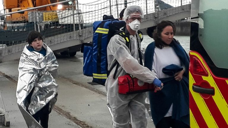 French rescue teams in Calais helping a group of 17 migrants rescued while trying to reach England by crossing the Channel on an inflatable boat