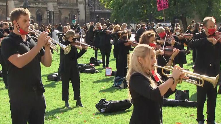Musicians perform near the houses of Parliament during a protest highlighting their inability to perform live or work during the coronavirus pandemic.
