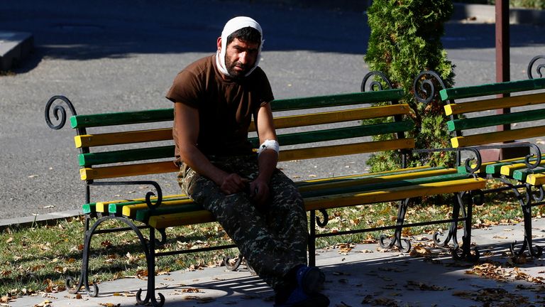 An injured man sits on a bench near a hospital in Stepanakert in the breakaway region of Nagorno-Karabakh