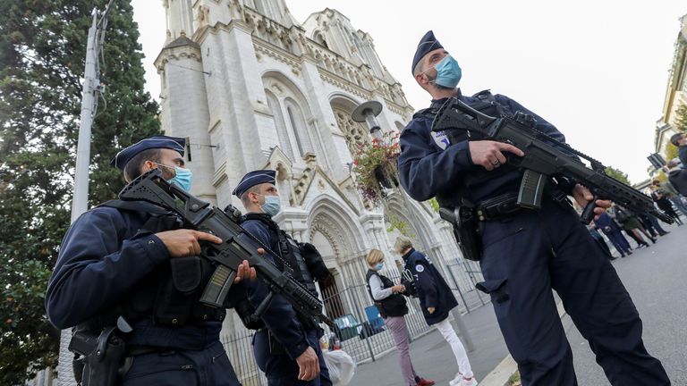 Police officers stand guard at the Notre Dame church