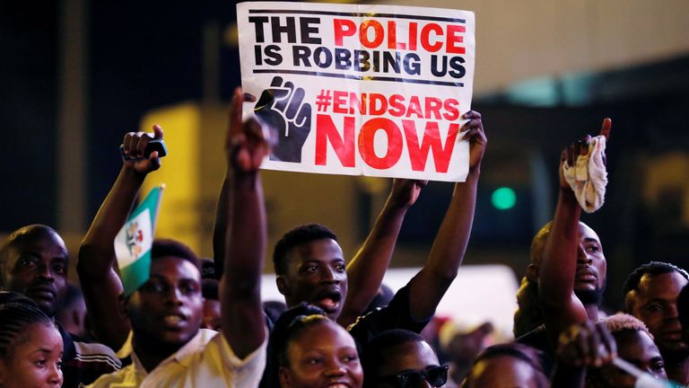 A demonstrator holds a sign during a protest