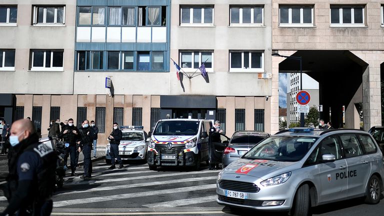 Police officers outside the Champigny-sur-Marne police station after the attack