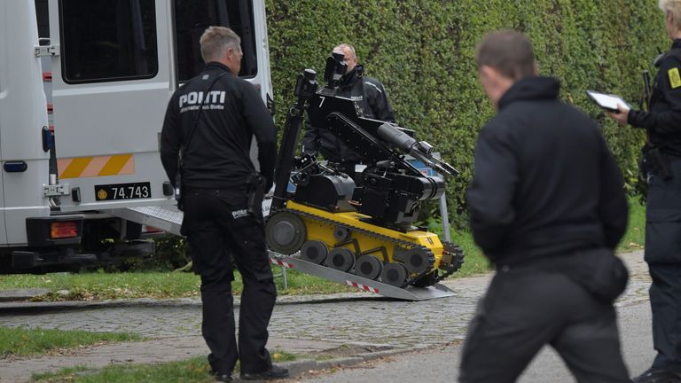 Police officers are seen as Peter Madsen (not pictued) is surrounded by the police in Albertslund, Denmark October 20, 2020. Ritzau Scanpix/Nils Meilvang via REUTERS ATTENTION EDITORS - THIS IMAGE WAS PROVIDED BY A THIRD PARTY. DENMARK OUT. NO COMMERCIAL OR EDITORIAL SALES IN DENMARK.