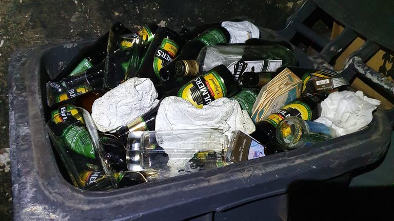 A container outside the premises was full of empty drink bottles.