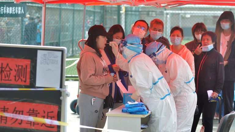 Medical workers in protective suits collect swab tests in Qingdao