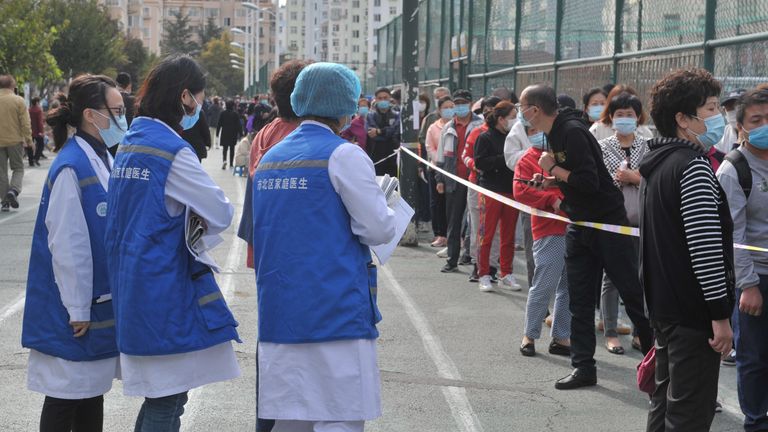 People line up at a coronavirus testing site in Qingdao following the report of new cases