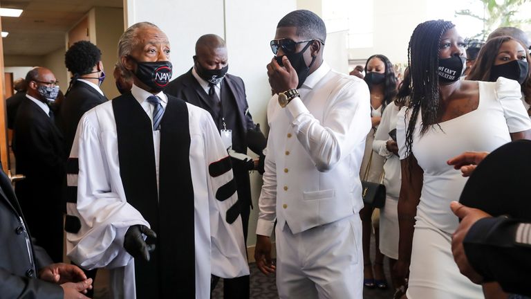Quincy Floyd (R) pictured with Rev Al Sharpton at his father’s funeral 