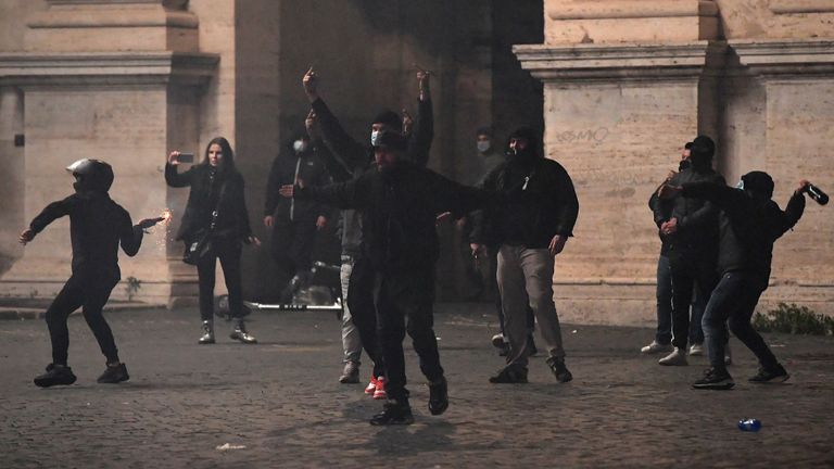 People clash with police as they protest against the government restriction measures to curb the spread of Covid-19 in Rome, on October 27, 2020. - Thousands of Italian protesters angry over new restrictions announced to control the spread of coronavirus clashed with police in cities on October 26, 2020, following weekend demonstrations that saw violence in Italy, as European governments toughened their responses to the contagion. (Photo by Tiziana FABI / AFP) (Photo by TIZIANA FABI/AFP 