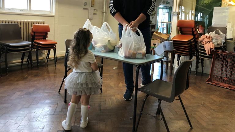 Two-year-old Rose collects food in Coventry