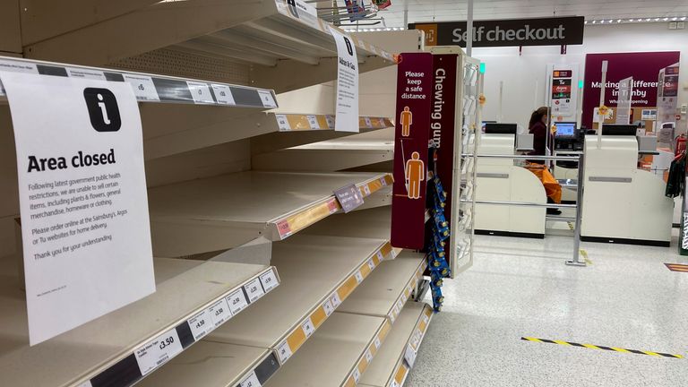 Empty shelves in seen a closed part of a Sainsbury&#39;s store