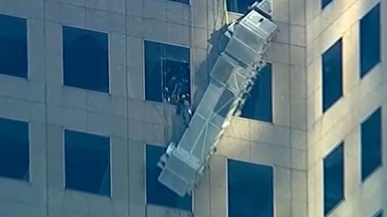Two workers are rescued from broken scaffold lift outside 20th floor window of New York building