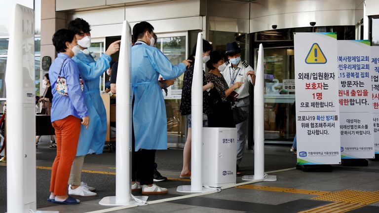 Visitors wearing masks to avoid the spread of the coronavirus disease (COVID-19) fill out a form which is mandatory to get into a hospital in Seoul
FILE PHOTO: Visitors wearing masks to avoid the spread of the coronavirus disease (COVID-19) fill out a form which is mandatory to get into a hospital in Seoul, South Korea, August 26, 2020. REUTERS/Kim Hong-Ji/File Photo
