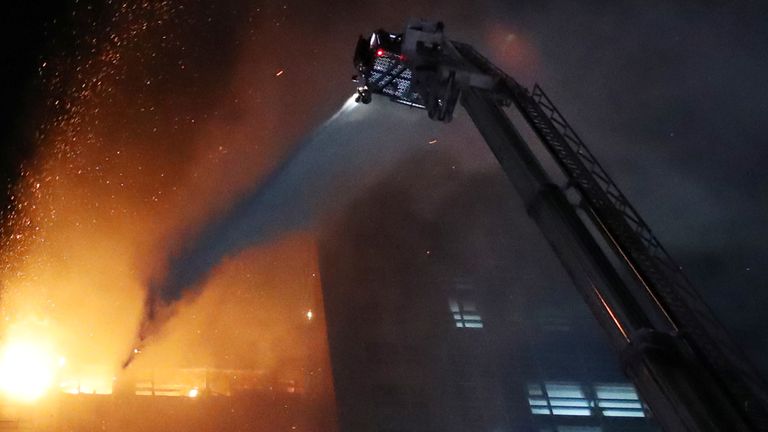 A water is sprayed to extinguish a fire at a mixed-use high-rise residential building in Ulsan, South Korea, October 9, 2020. Yonhap via REUTERS ATTENTION EDITORS - THIS IMAGE HAS BEEN SUPPLIED BY A THIRD PARTY. SOUTH KOREA OUT. NO RESALES. NO ARCHIVE.