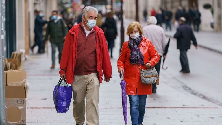 People wearing face masks walk in Burgos, northern Spain, on October 21, 2020, on the first day of a two week lockdown in an attempt to limit the contagion of the new coronavirus COVID-19 in the area. - Spain has become one of the pandemic&#39;s hotspots in the European Union, with close to 975,000 registered cases and nearly 34,000 deaths. (Photo by Cesar Manso / AFP) (Photo by CESAR MANSO/AFP via Getty Images)
