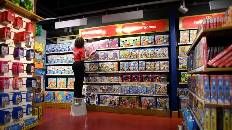 A shop assistant stacks toys on the shelves at the Hamleys toyshop in central London on October 15, 2020. (Photo by JUSTIN TALLIS / AFP) (Photo by JUSTIN TALLIS/AFP via Getty Images)
